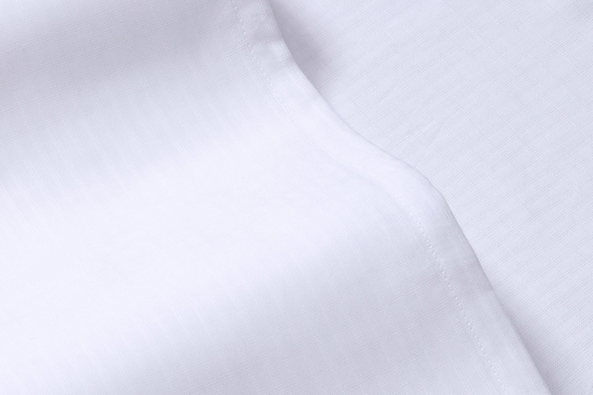 Close-up detail of a white bed sheet
