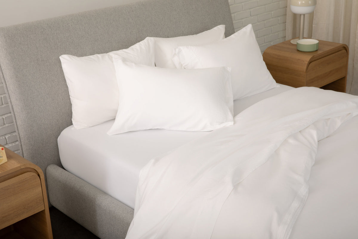 Fully dressed bed with white sheets