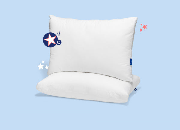 One pillow set on top of another against a light blue background