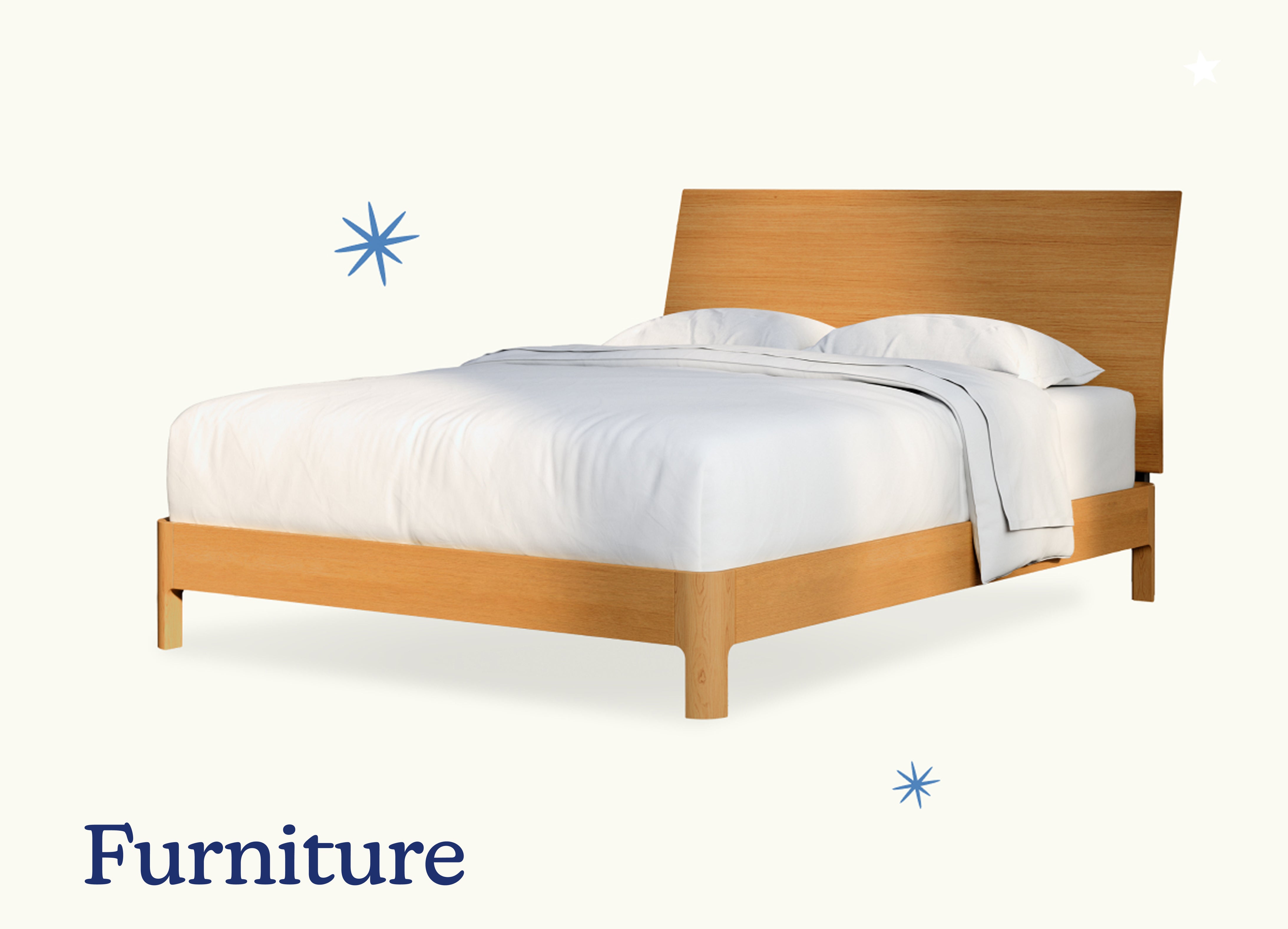 Furniture. A fully made bed on a wooden bed frame