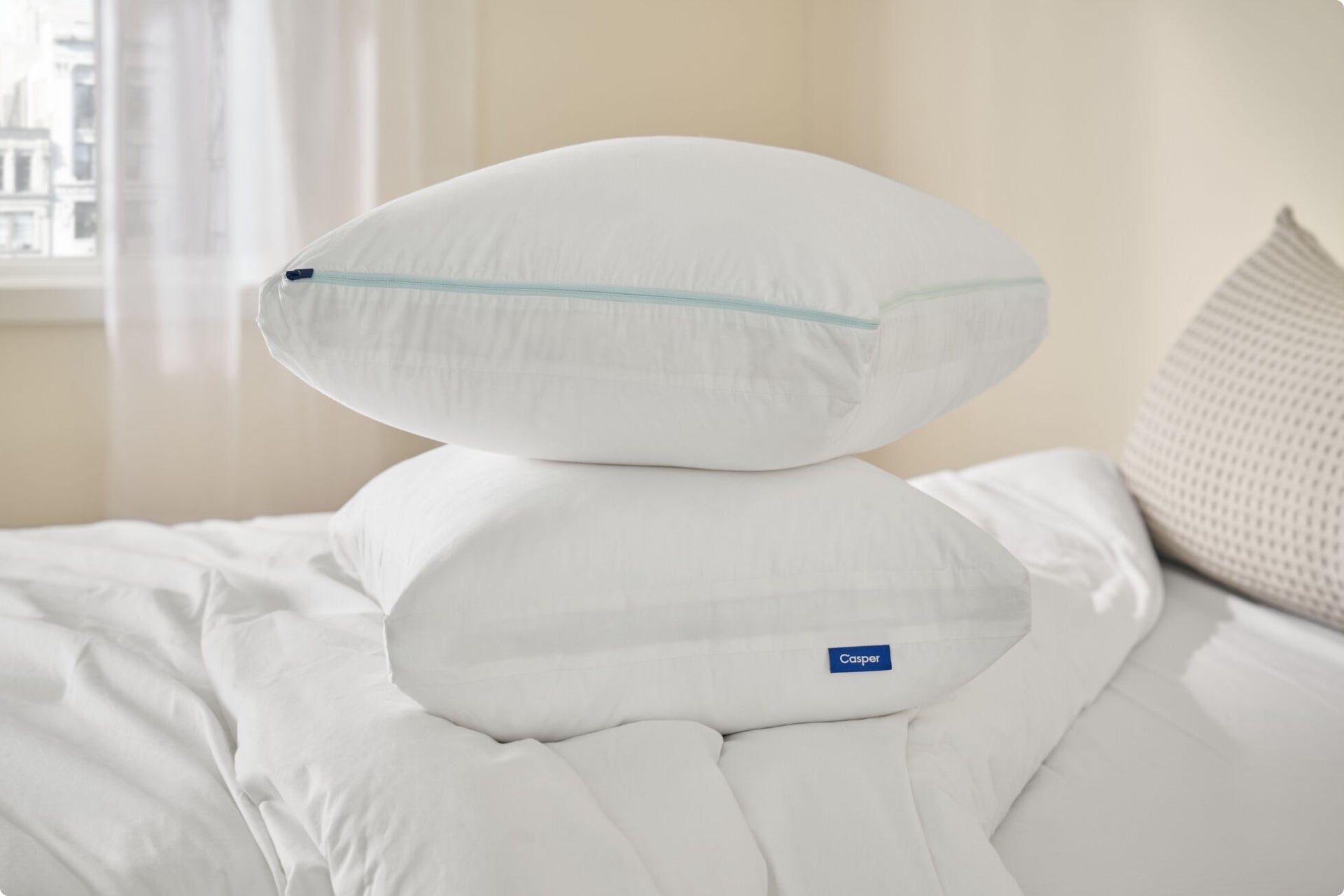 Two Original Cooling Pillows stacked on top of each other on a bed