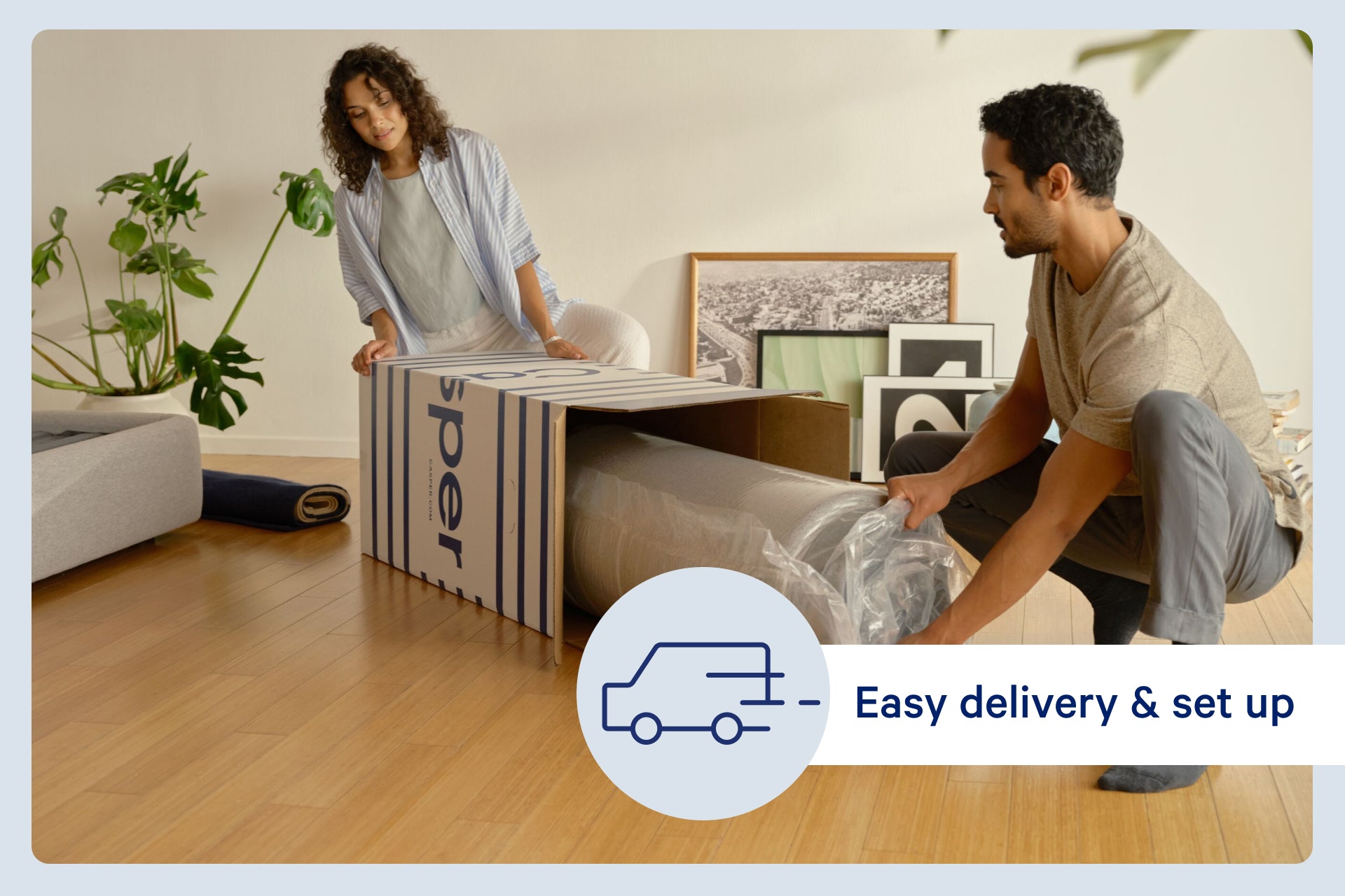 A couple unboxes their new Casper mattress in their bedroom. A small image with the outline of a traffic appears on the photo and says, "Easy delivery & setup."