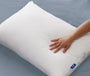 A hand feeling the Casper Original Pillow