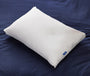 Casper's Original Pillow on a mattress with navy blue sheets