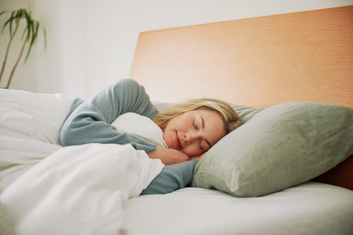 A woman sleeps on her side