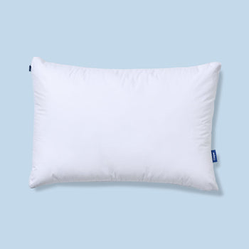 White pillow with a Casper label on a light blue background
