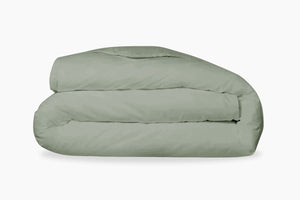 A folded, eucalyptus-green duvet cover against a light background
