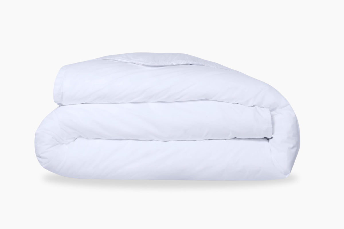 A folded, white duvet cover against a light background