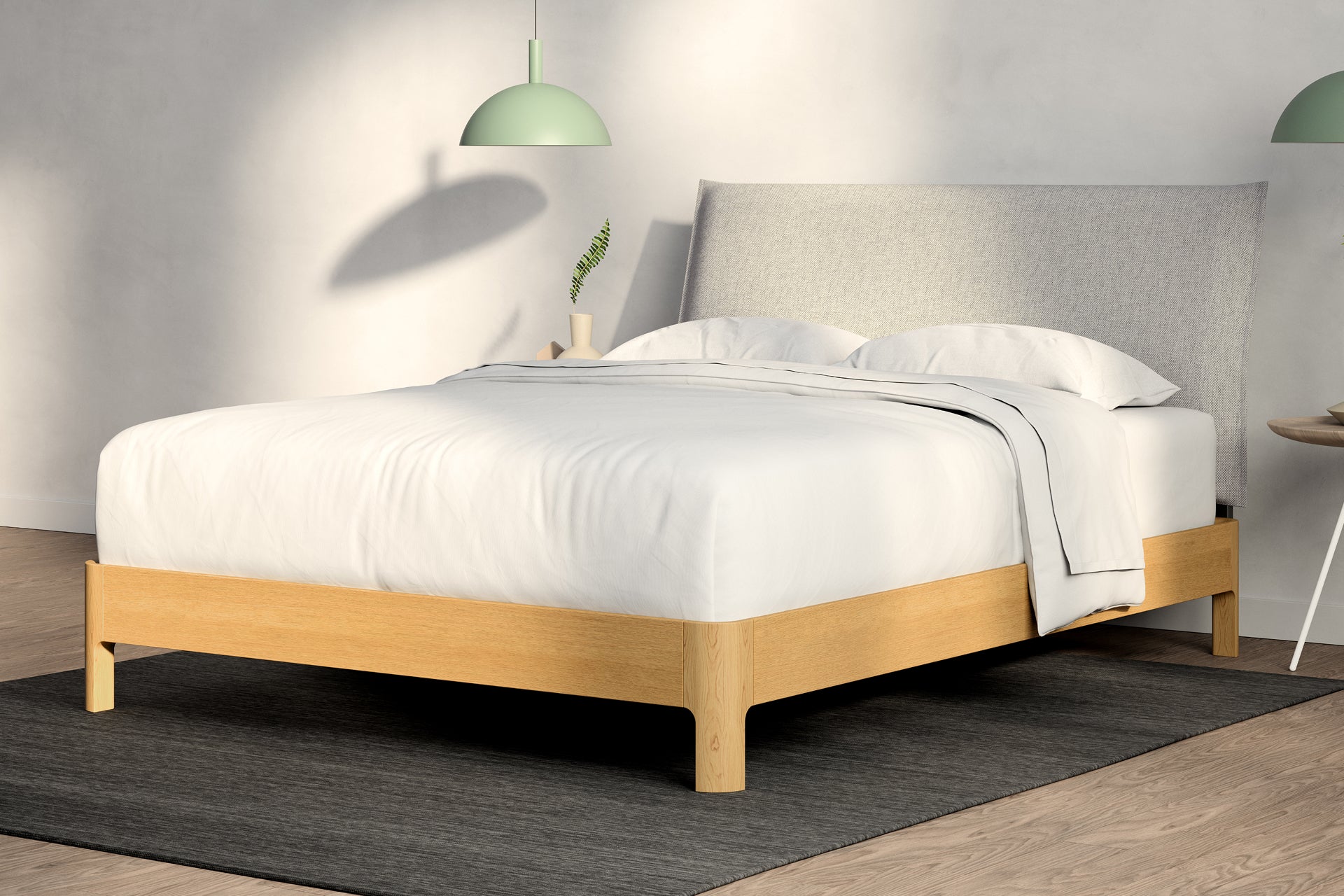 A fully made bed with a Repose Wooden Bed Frame. Corner View. Wooden bed frame is natural oak color. Repose Pillow Headboard is Light Gray color.