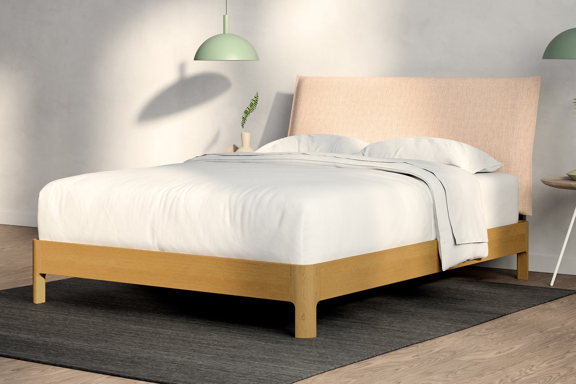 A fully made bed with a Repose Wooden Bed Frame. Corner View. Wooden bed frame is natural oak color. Repose Pillow Headboard is Pink color.