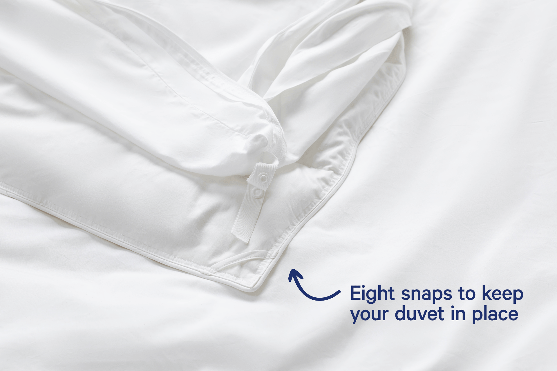 A short, stop-motion video of a duvet cover being snapped together. Text on the image reads 'Eight snaps to keep your duvet in place'