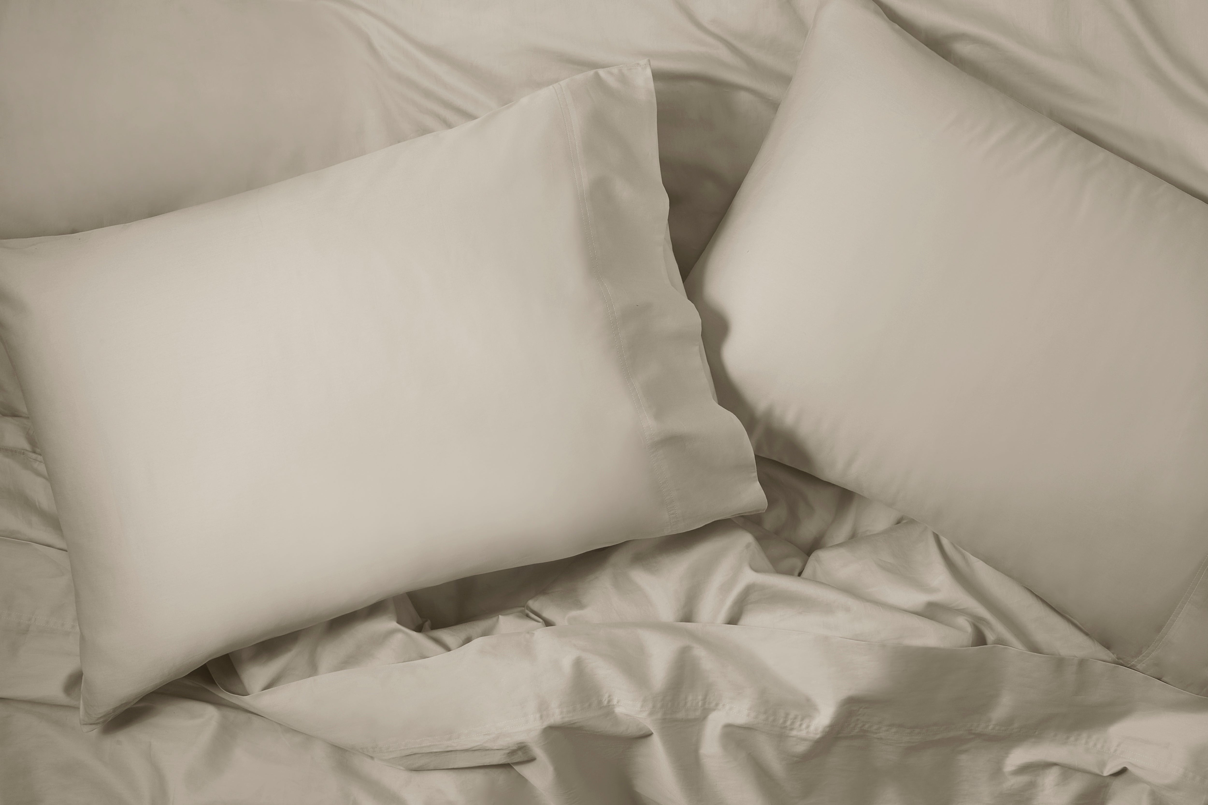Overhead view of a bed with Sateen Sheet Set, oatmilk