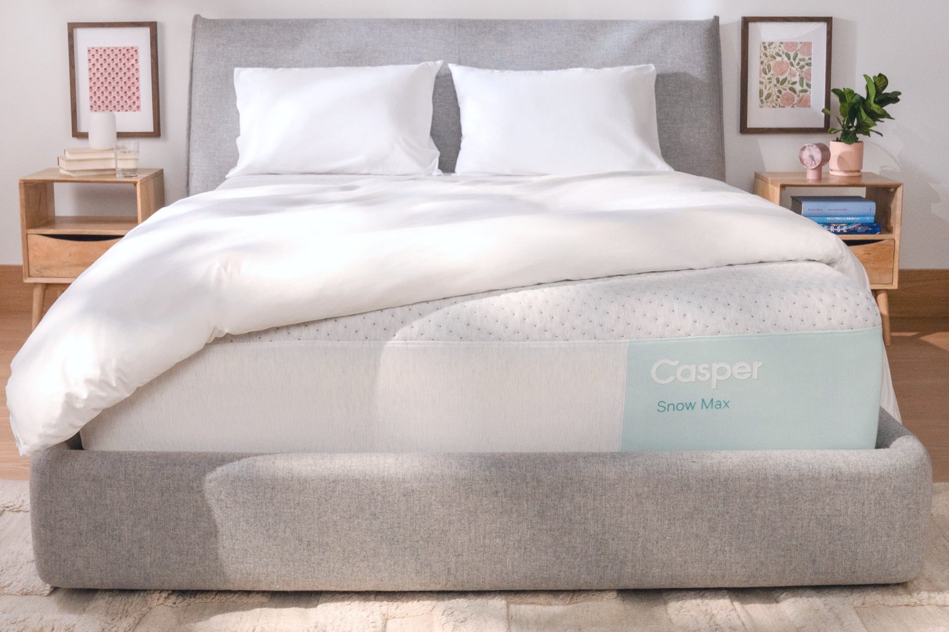 Casper's Snow Max mattress on a bed with two pillows and a folded blanket on top.