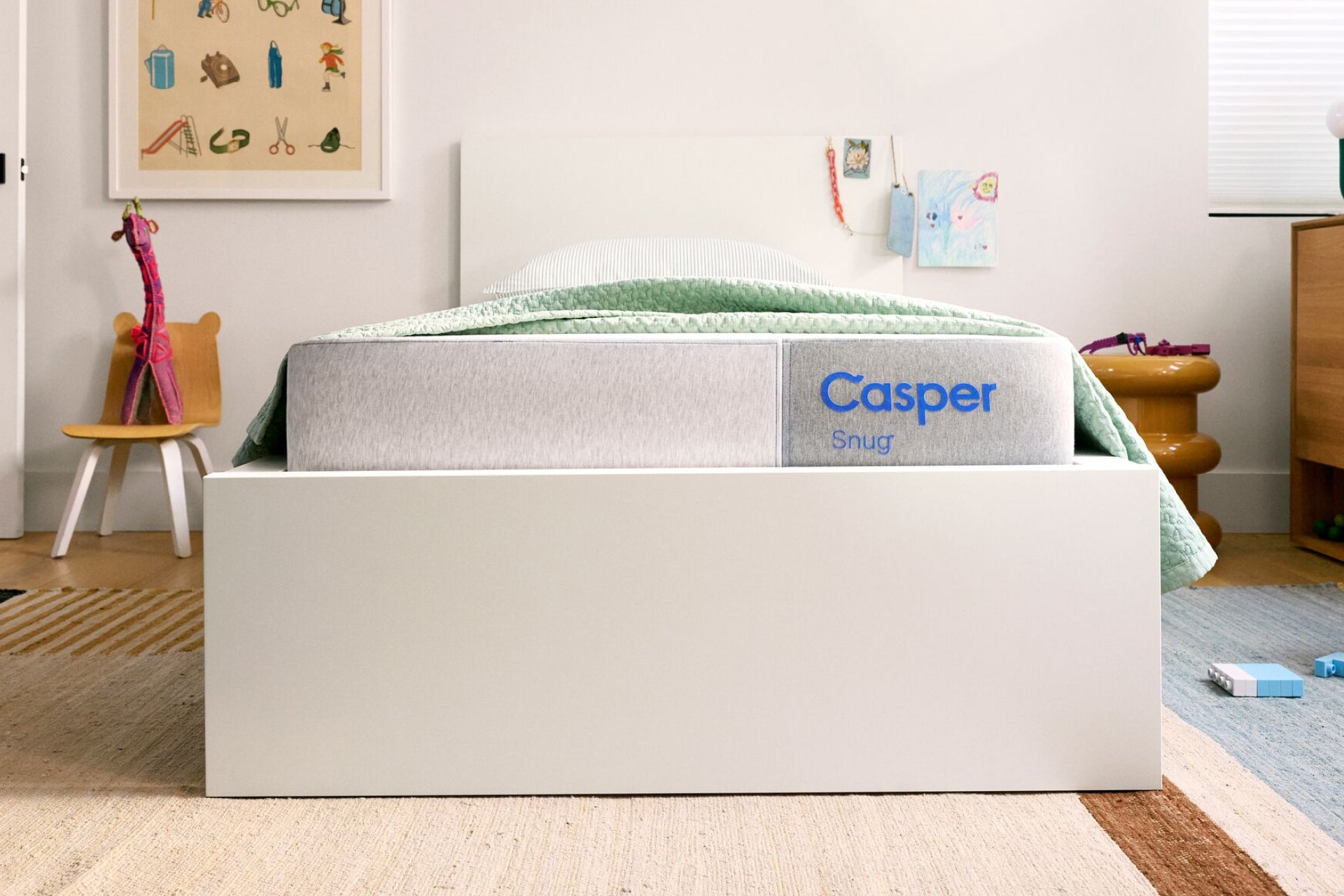Front-facing view of the Casper Snug kids mattress in a bedroom setting.