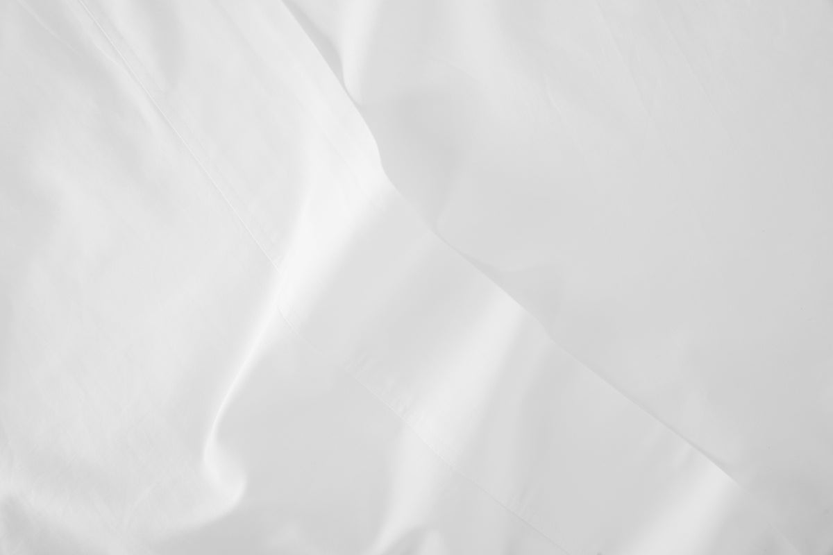Close-up detail of a white bed sheet