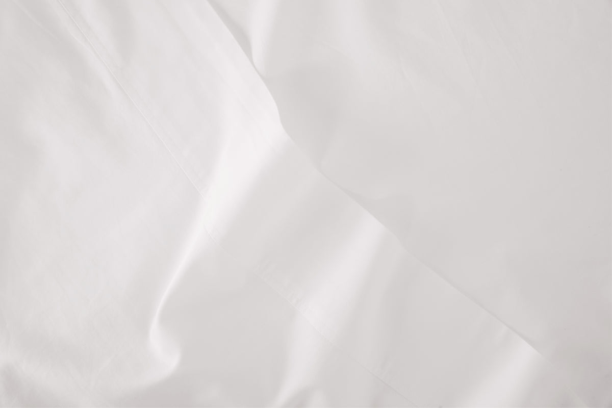 Close-up detail of a white bed sheet
