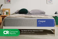 Casper's The One mattress on a bed frame with a blanket and pillows on top in a bedroom setting. At the bottom of the image is the Consumer Reports logo. The One is the top-rated all-foam mattress of 2025. See below to learn more. Consumer Reports does not endorse products or service.
