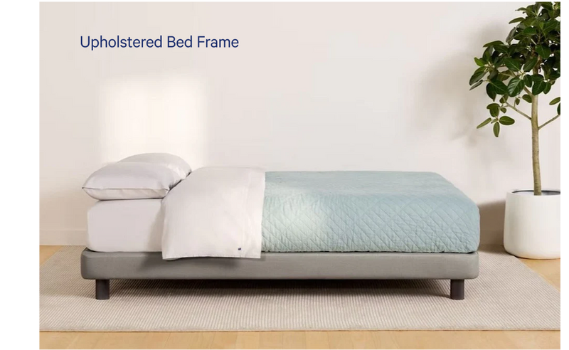 Side view of a fully made bed. The mattress sits atop Casper's Upholstered Bed Frame.