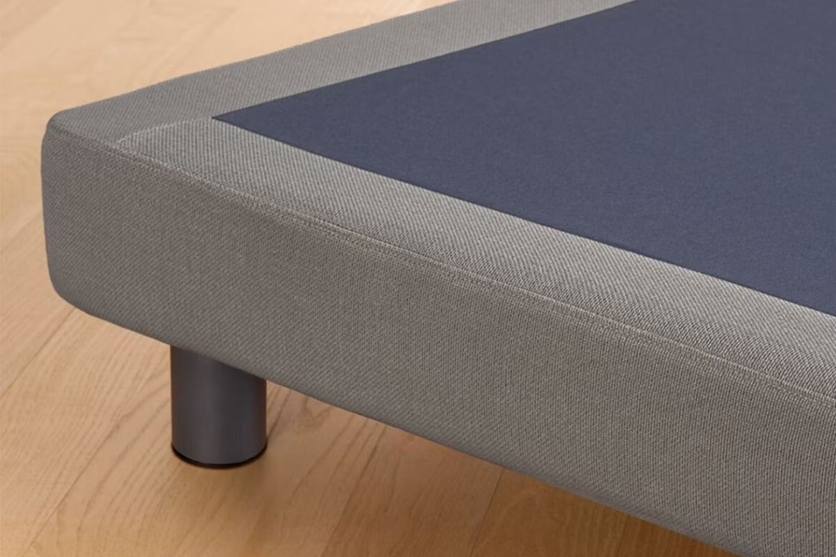 Corner of the Upholstered Bed Frame, gray color.
