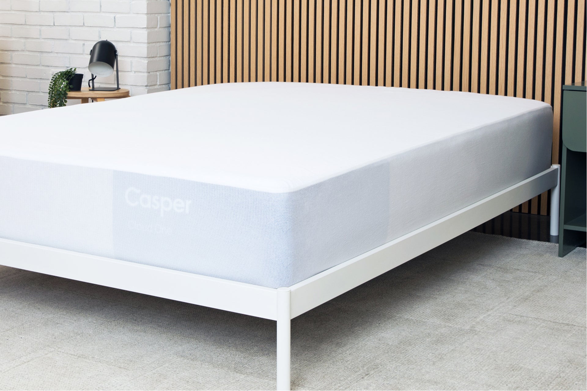 A waterproof mattress protector covering an entire mattress on a bed frame