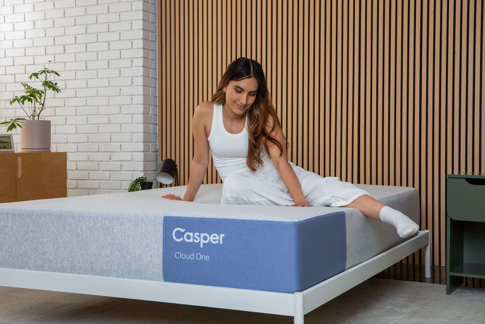 Woman sitting on a Casper Cloud One mattress