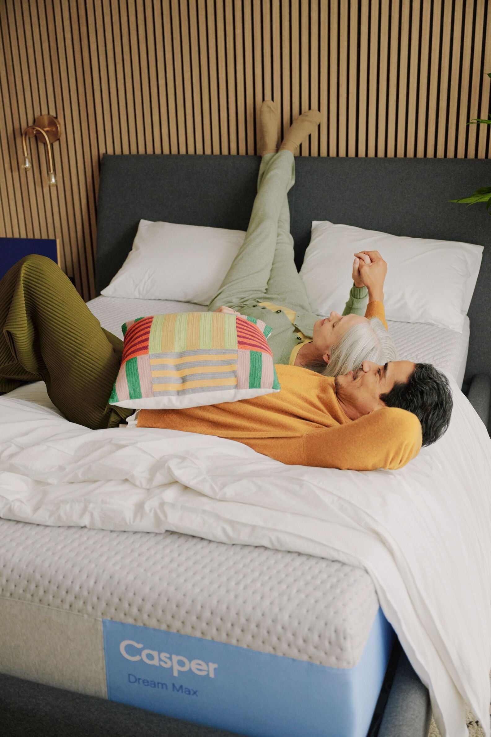 couple laying on Dream Max Mattress and Haven bedframe