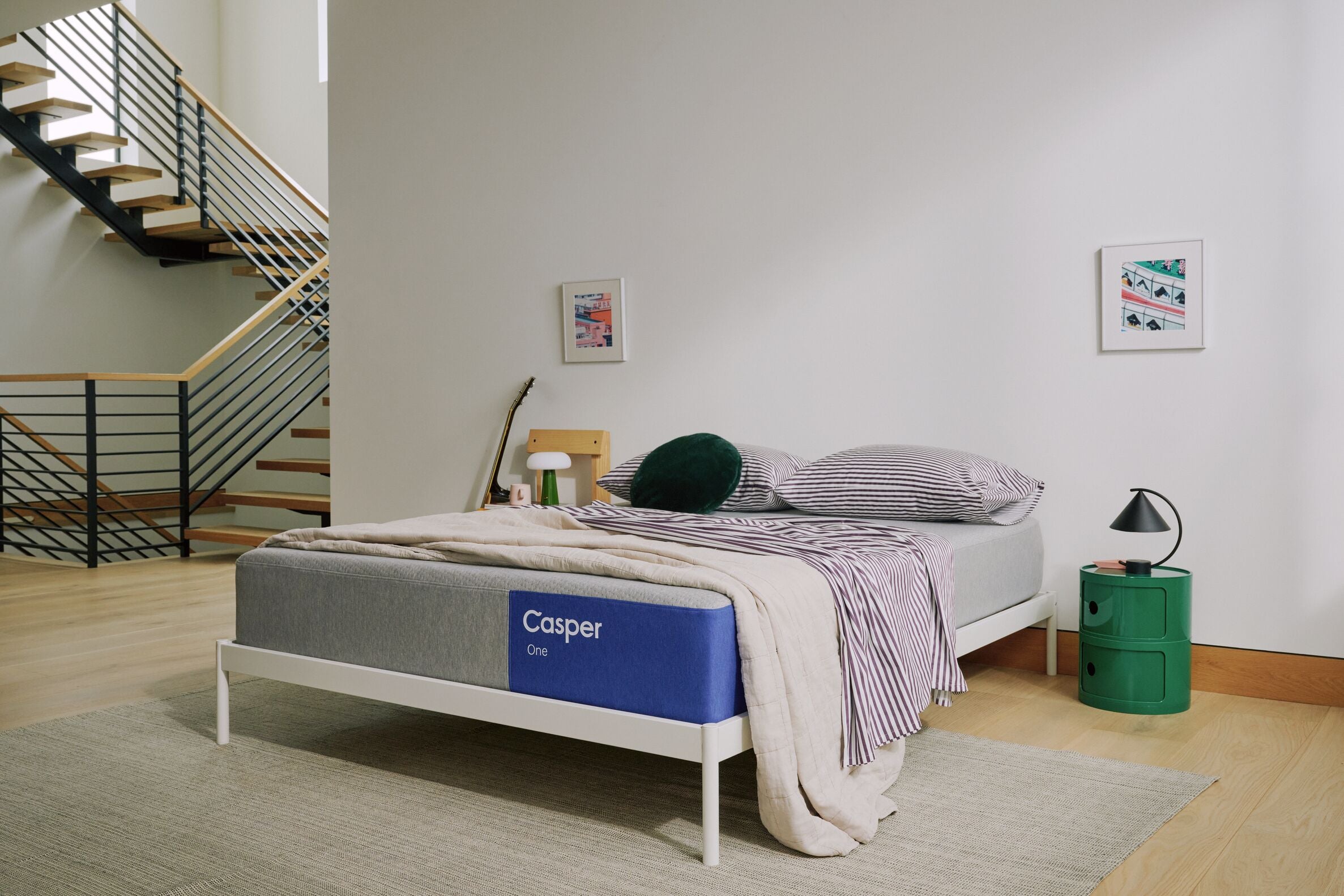 Casper mattress in a room with a staircase and lamp.