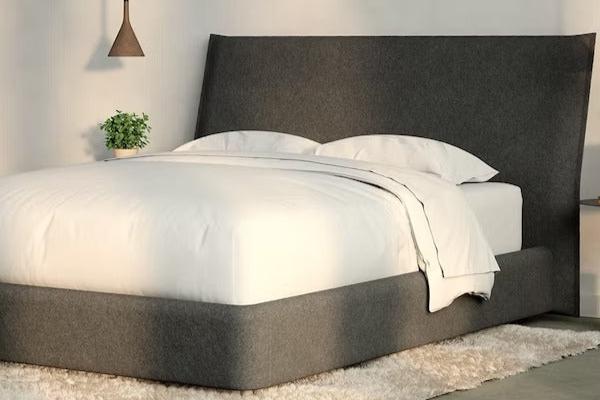 A fully made bed with a Haven Bed Frame and headboard. Corner view.